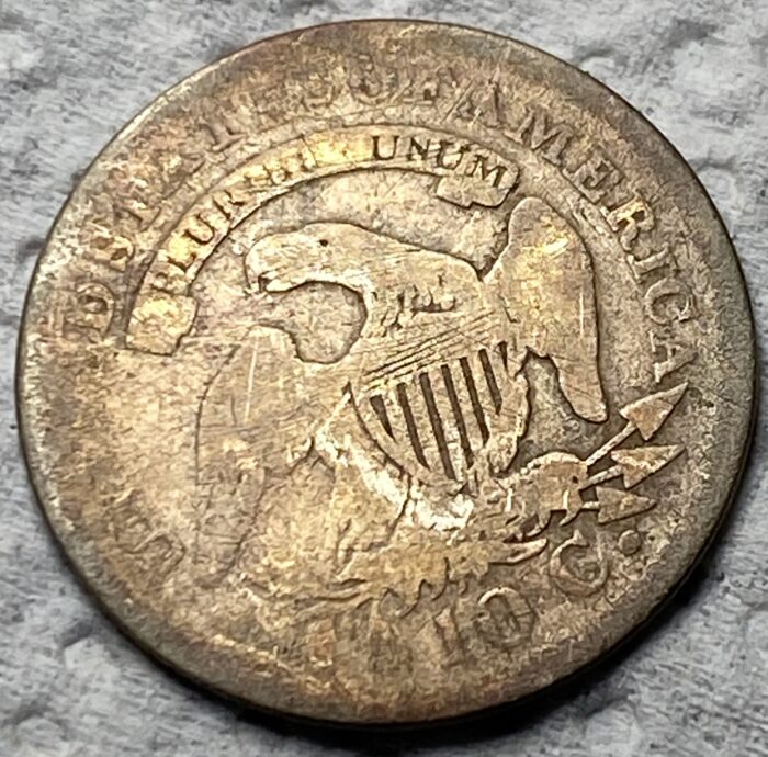 Close-up of old American coin featuring an eagle.