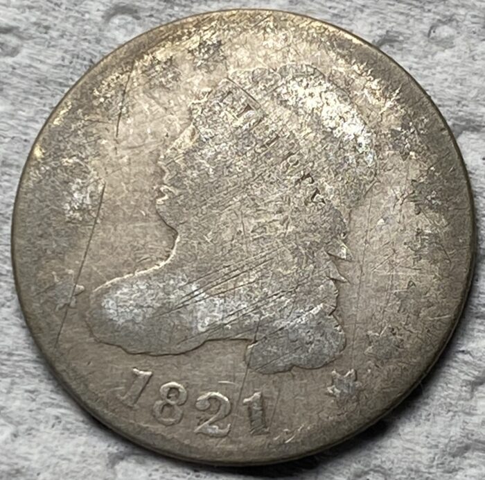 1821 silver coin with worn face and stars