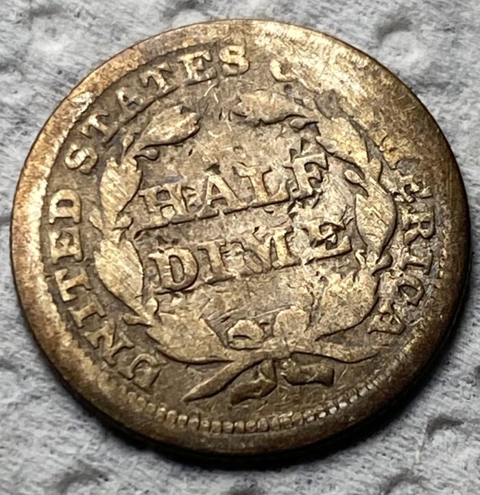 Old United States half dime coin close-up view.