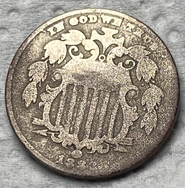 1882 Shield nickel showing intricate design.