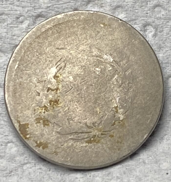 Worn, unrecognizable coin with faint details