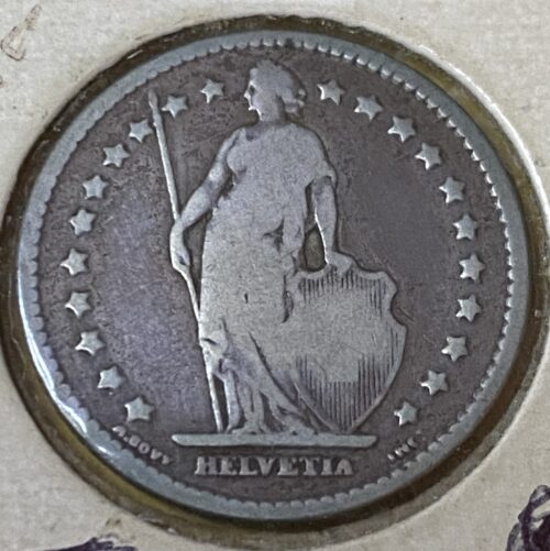 Swiss Helvetia coin with standing figure and stars.