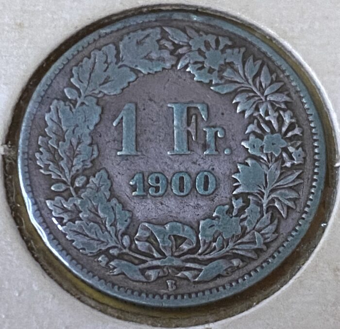 1900 Swiss 1 franc coin with floral design.