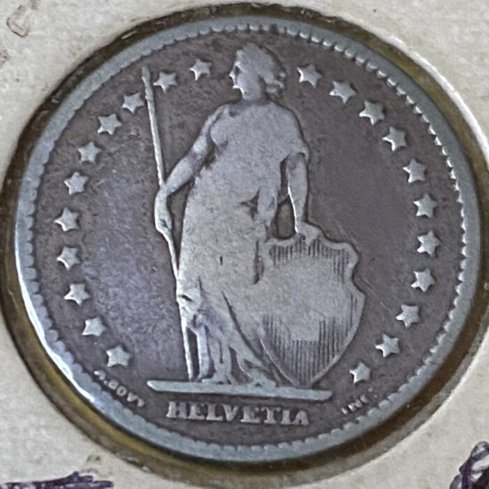 Swiss Helvetia coin with figure and stars