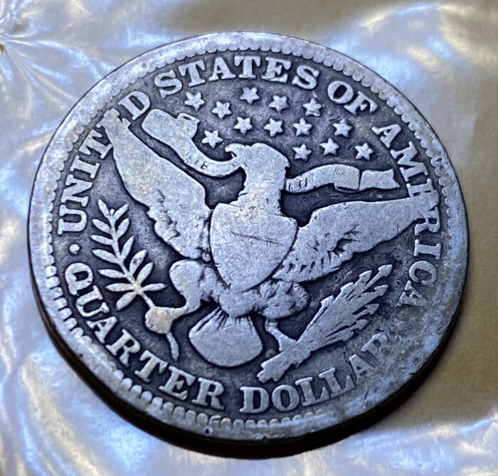 Vintage United States quarter dollar with eagle design.