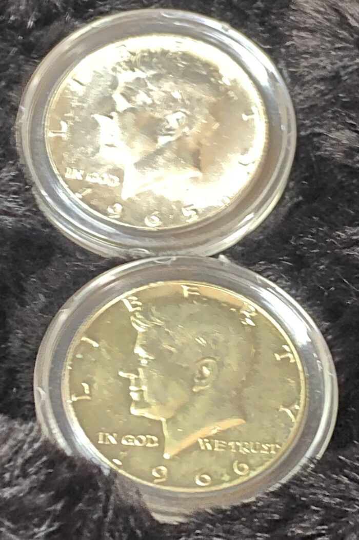 Two Kennedy half-dollar coins in holders