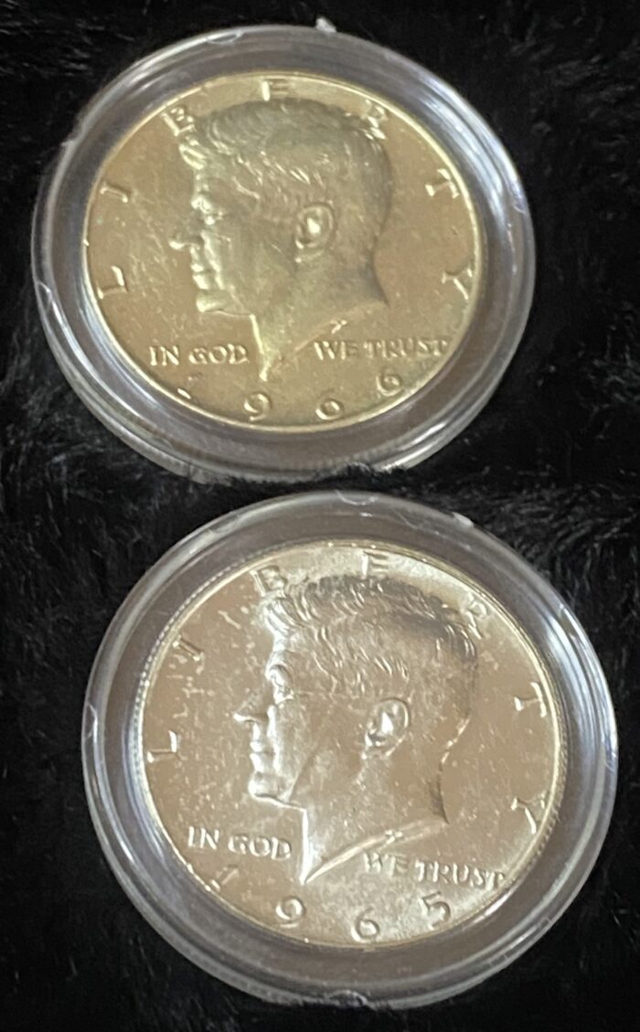 Two Kennedy half-dollar coins in protective cases.