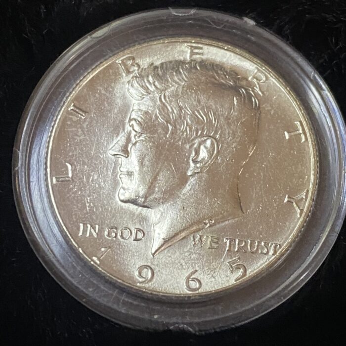 1965 Kennedy half dollar in clear case.