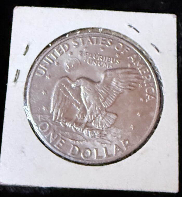 Silver dollar coin with eagle design.