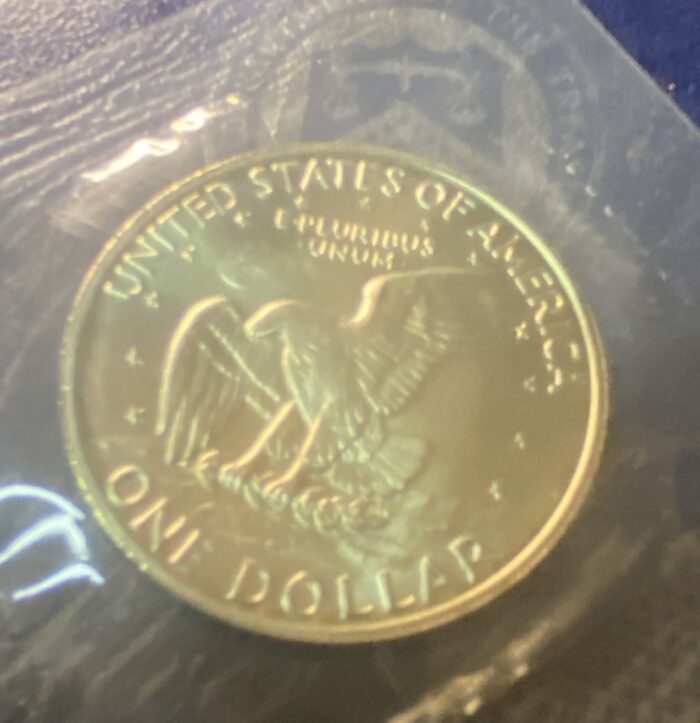 Golden one dollar coin with eagle design.