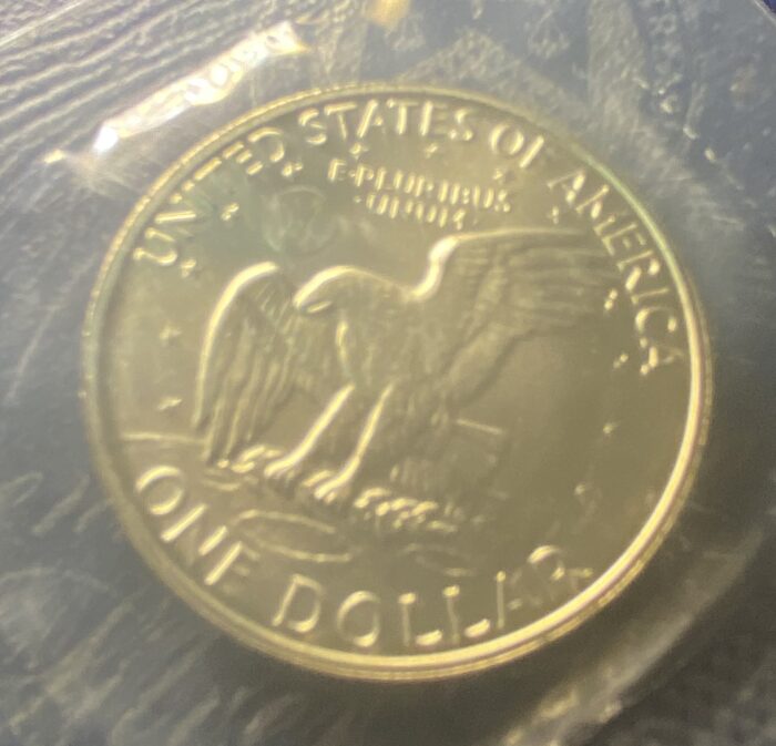 US gold one dollar coin with eagle design.