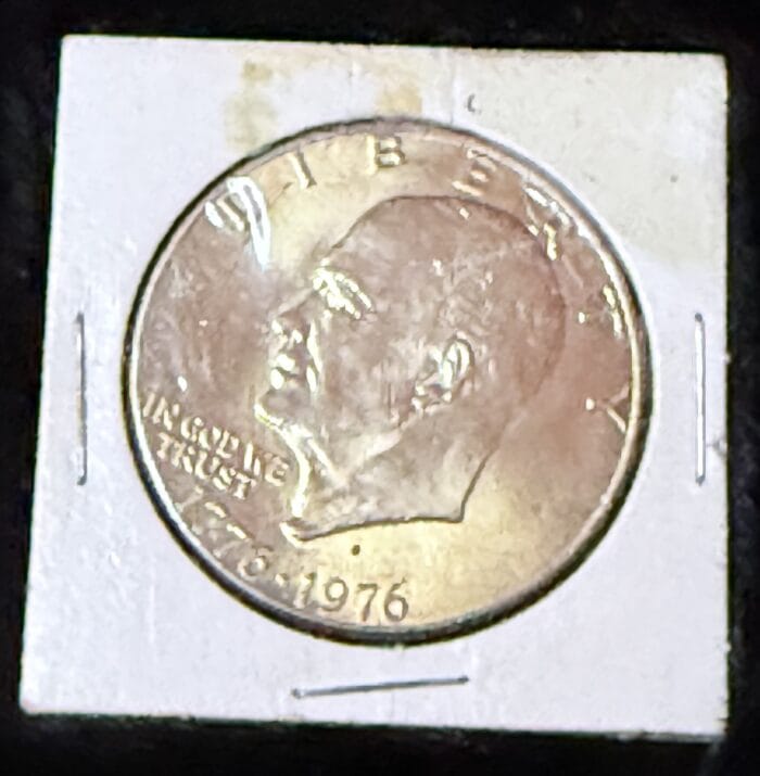 1976 Eisenhower dollar coin in holder, close-up