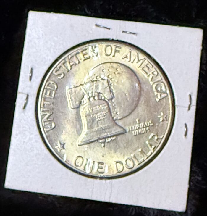 Eisenhower dollar coin, Liberty Bell and moon design.