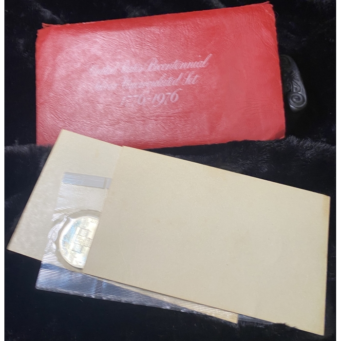 1976 bicentennial coin set with red folder.
