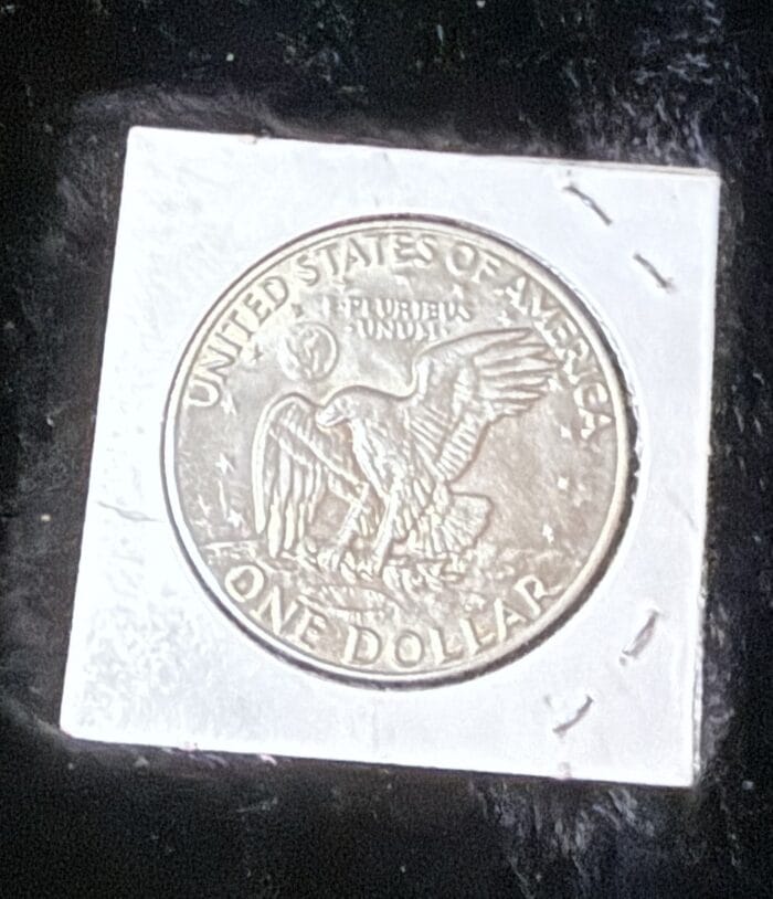 American one dollar coin with eagle design.