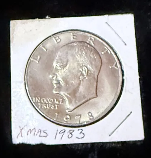 1978 coin with head profile and Xmas 1983 note.