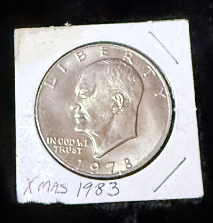 1978 coin with head profile and Xmas 1983 note.