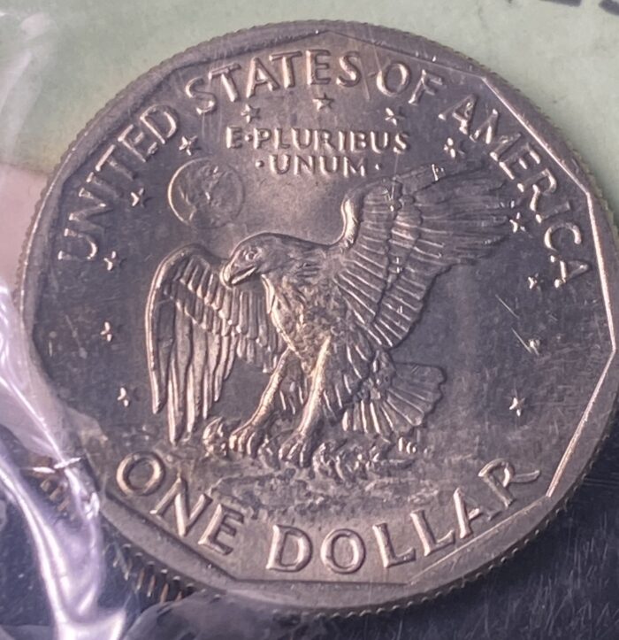 United States one dollar coin with eagle design.