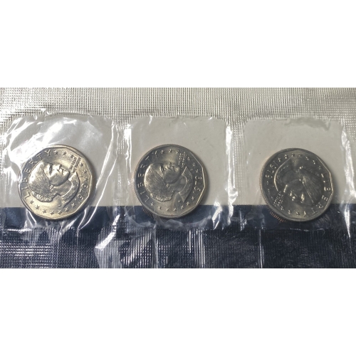 Three Susan B. Anthony dollar coins in plastic sleeves.