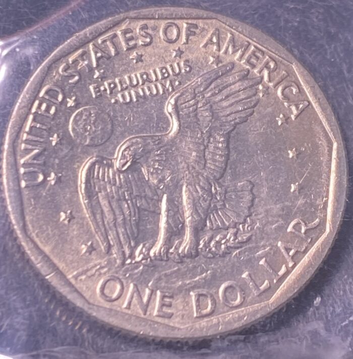 United States one dollar coin with eagle design.