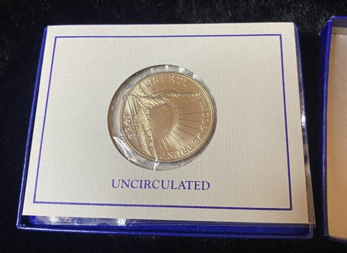 Uncirculated commemorative coin display with Liberty design.