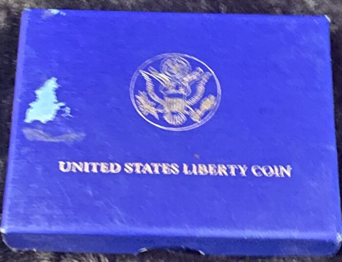 Blue box with United States Liberty Coin logo.