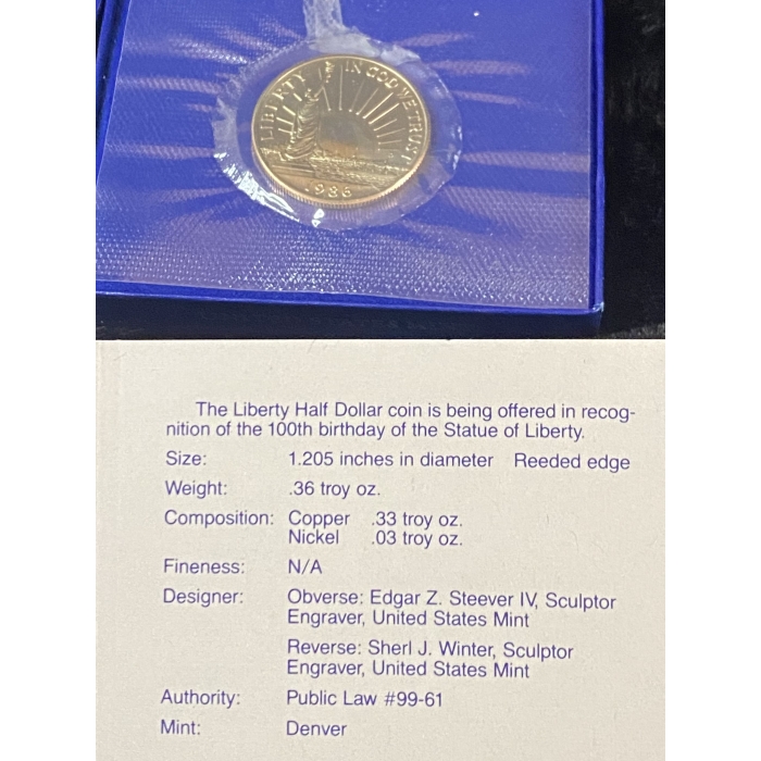 Liberty Half Dollar coin with informational card.