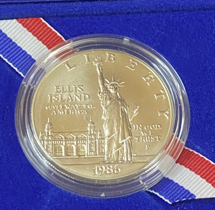 1986 Ellis Island Liberty coin in blue case.