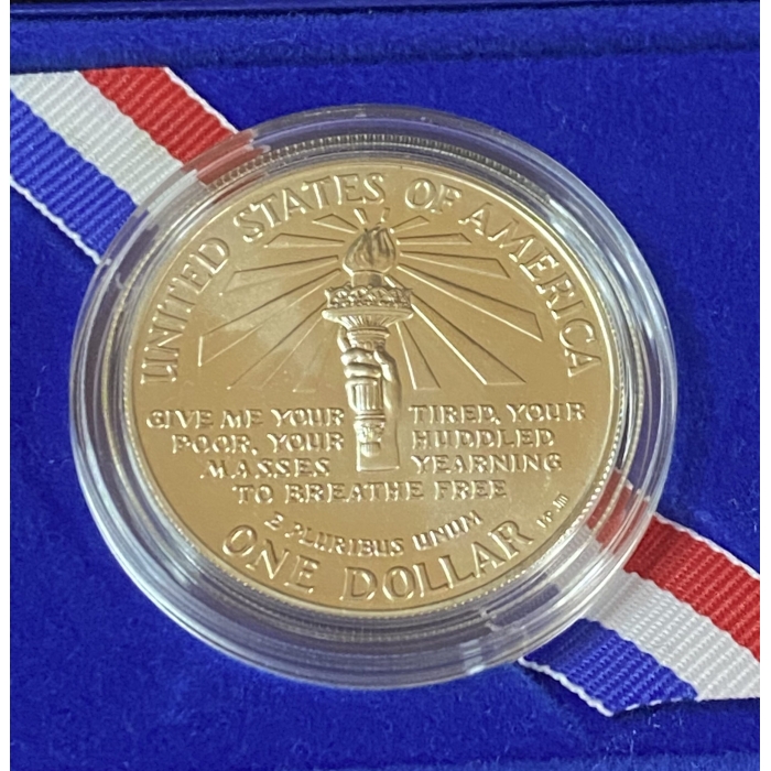 Gold commemorative coin with torch design, blue background