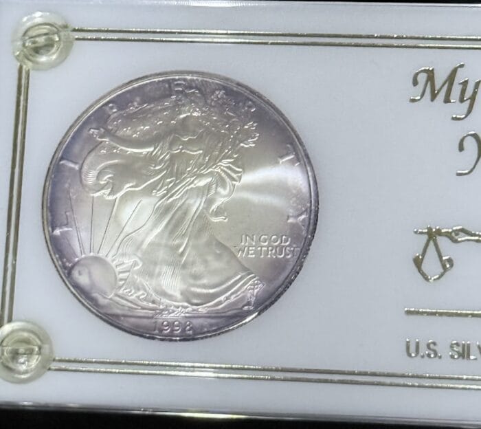 1993 American Silver Eagle coin in display case.