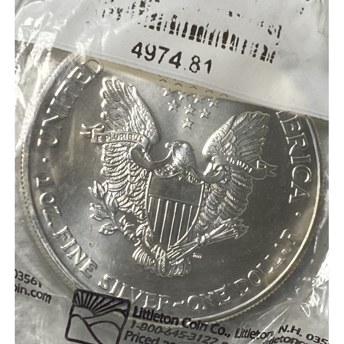 Silver dollar coin with eagle design.