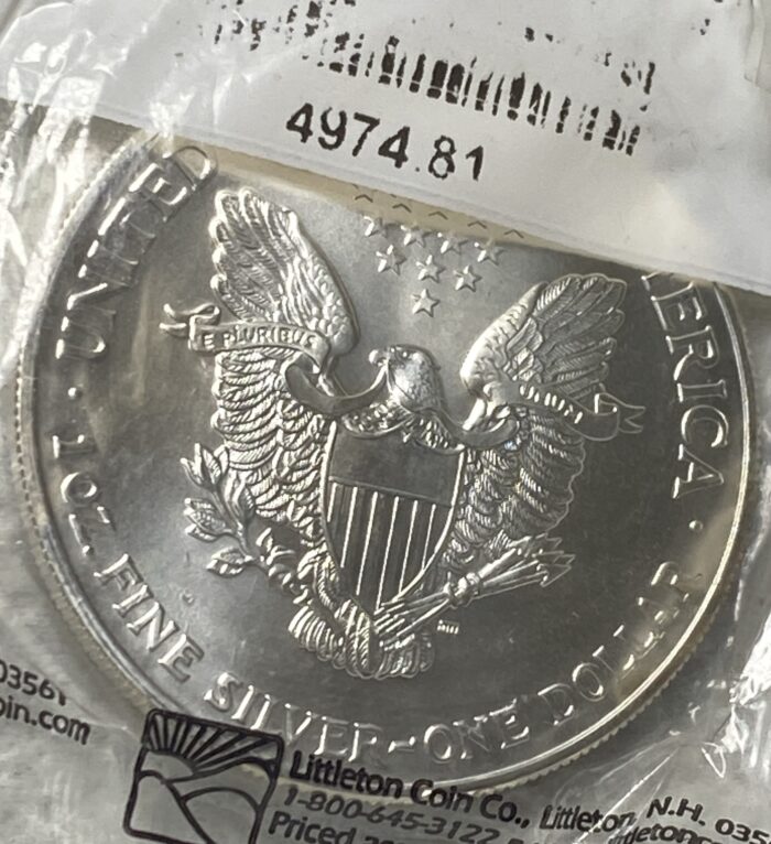 Silver dollar coin with eagle design.