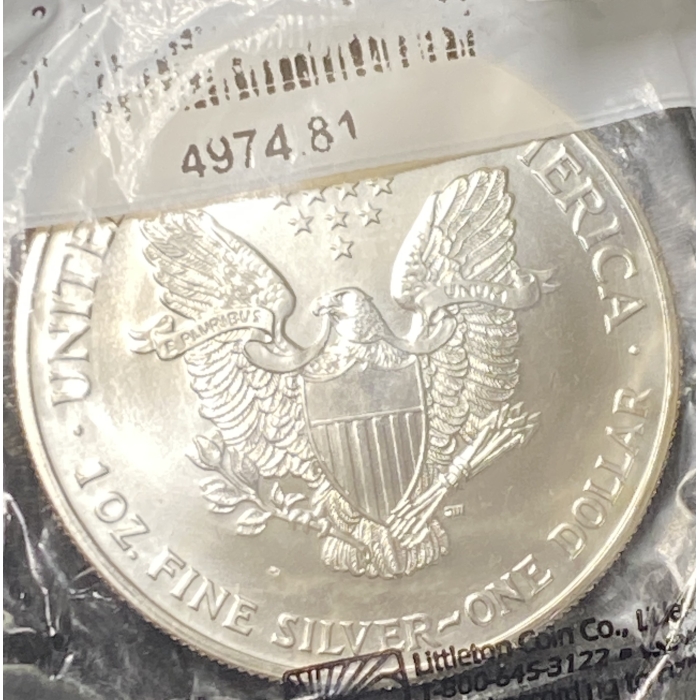 Silver coin with eagle and stars design.