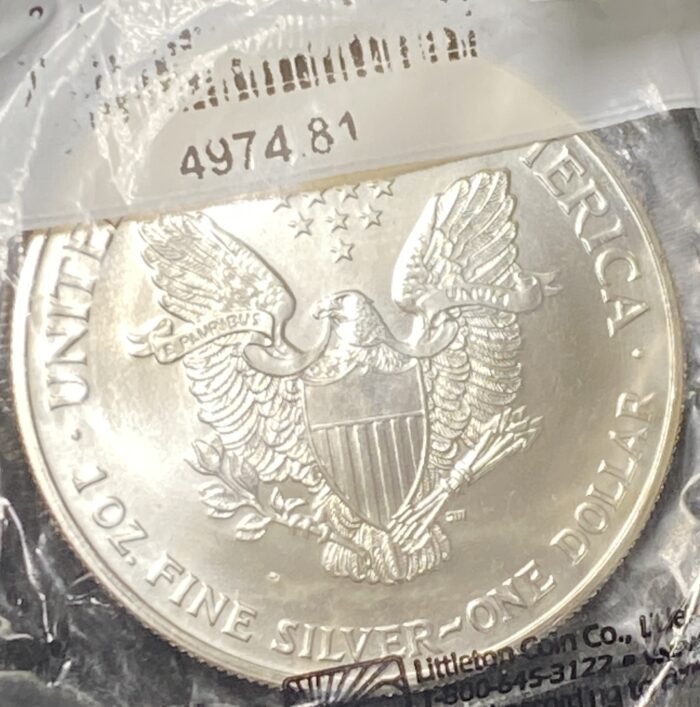 Silver coin with eagle and stars design.