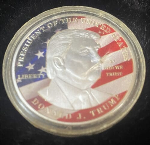 Coin with US flag and profile silhouette.