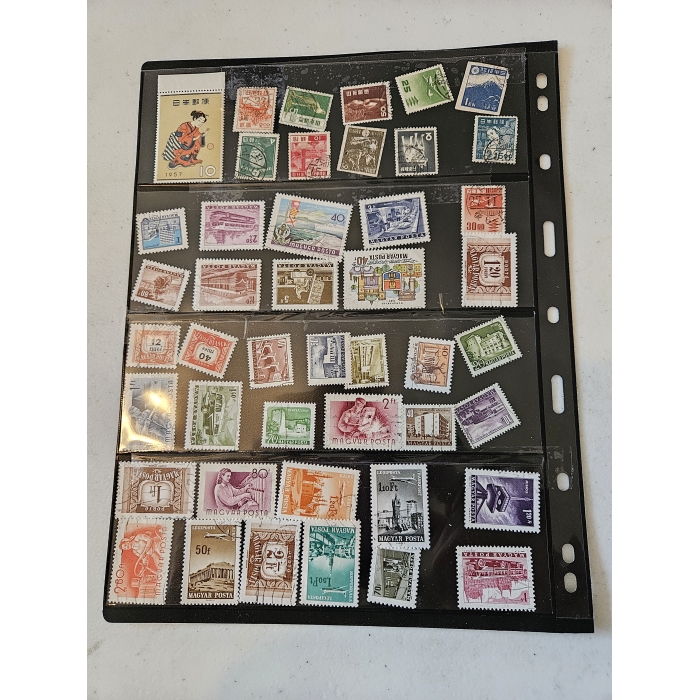 Collection of international postage stamps in plastic sheet.
