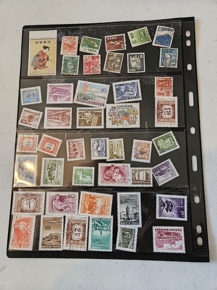 Collection of international postage stamps in plastic sheet.