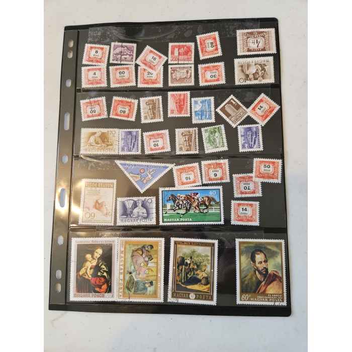 Collection of vintage Hungarian postage stamps in album.