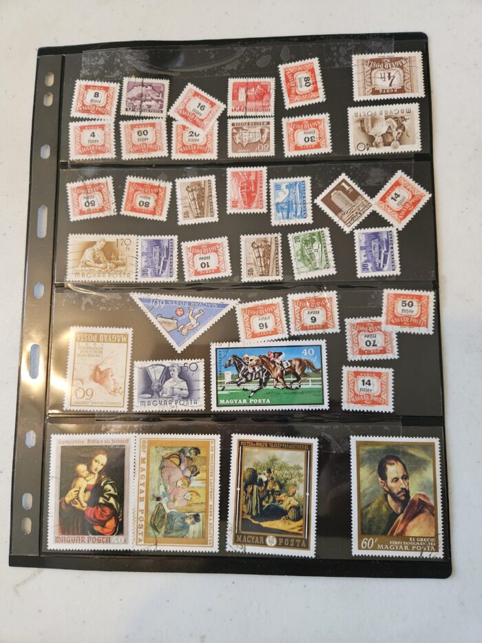 Collection of vintage Hungarian postage stamps in album.