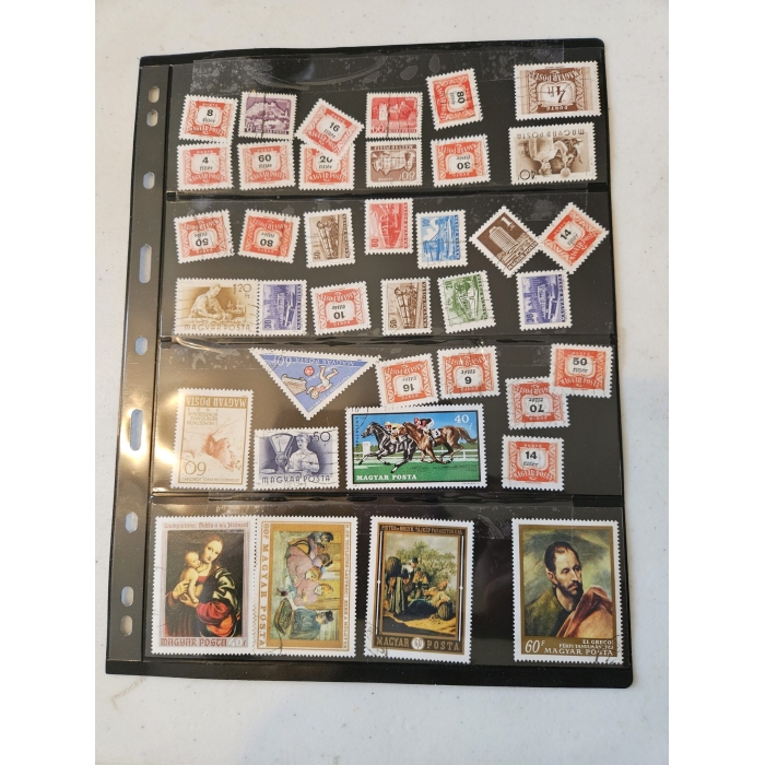 Collection of vintage Hungarian postage stamps in album.