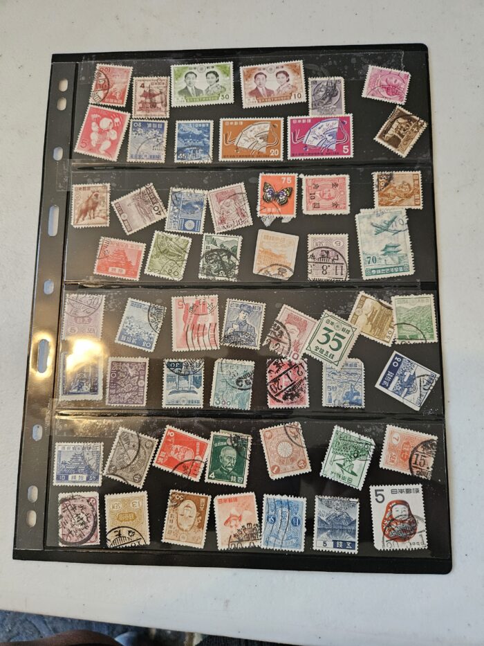 Collection of various international postage stamps in a holder.