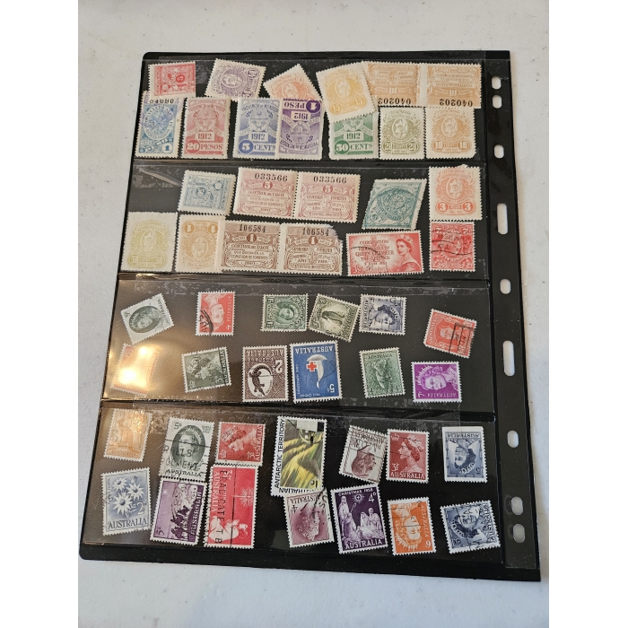 Vintage postal stamp collection in a black album.
