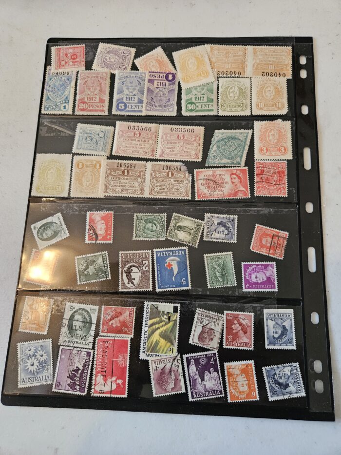 Vintage postal stamp collection in a black album.