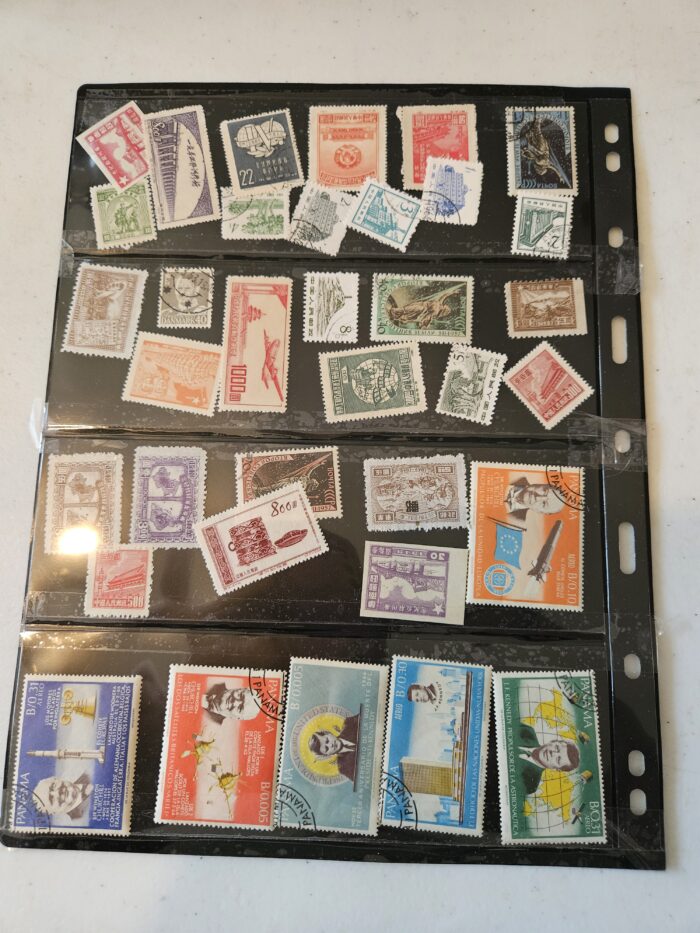 Collection of international postage stamps on display sheet.