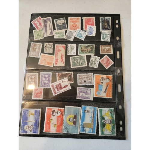 Collection of international postage stamps on display sheet.