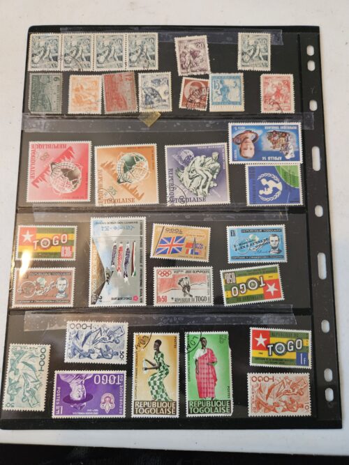 Collection of international postage stamps on display sheet.