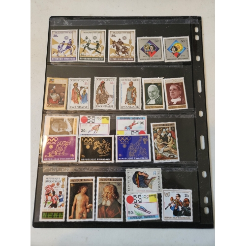 Collection of vintage Rwandan stamps in album.