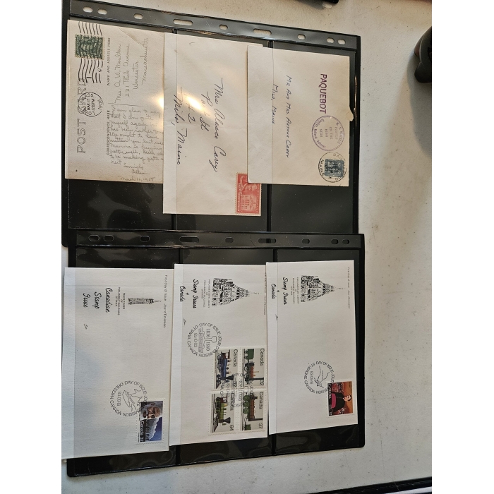 Collection of vintage postcards and envelopes displayed.