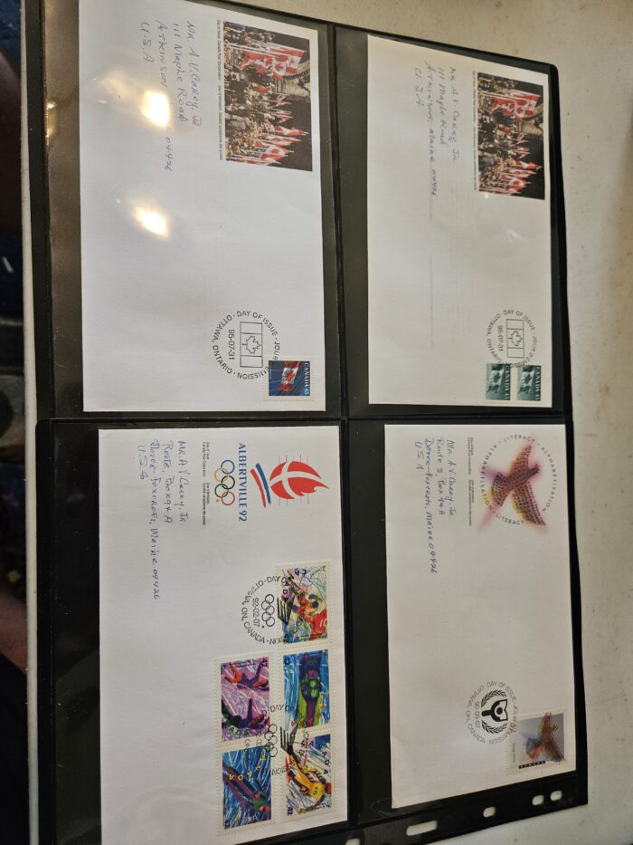 Four commemorative envelopes with stamps and postmarks.