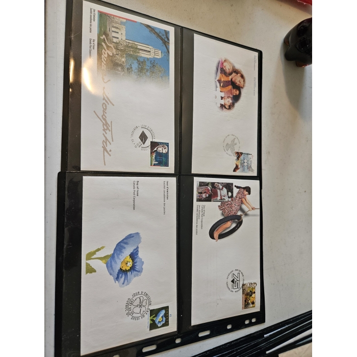 Four collectible envelopes with stamps and graphics.